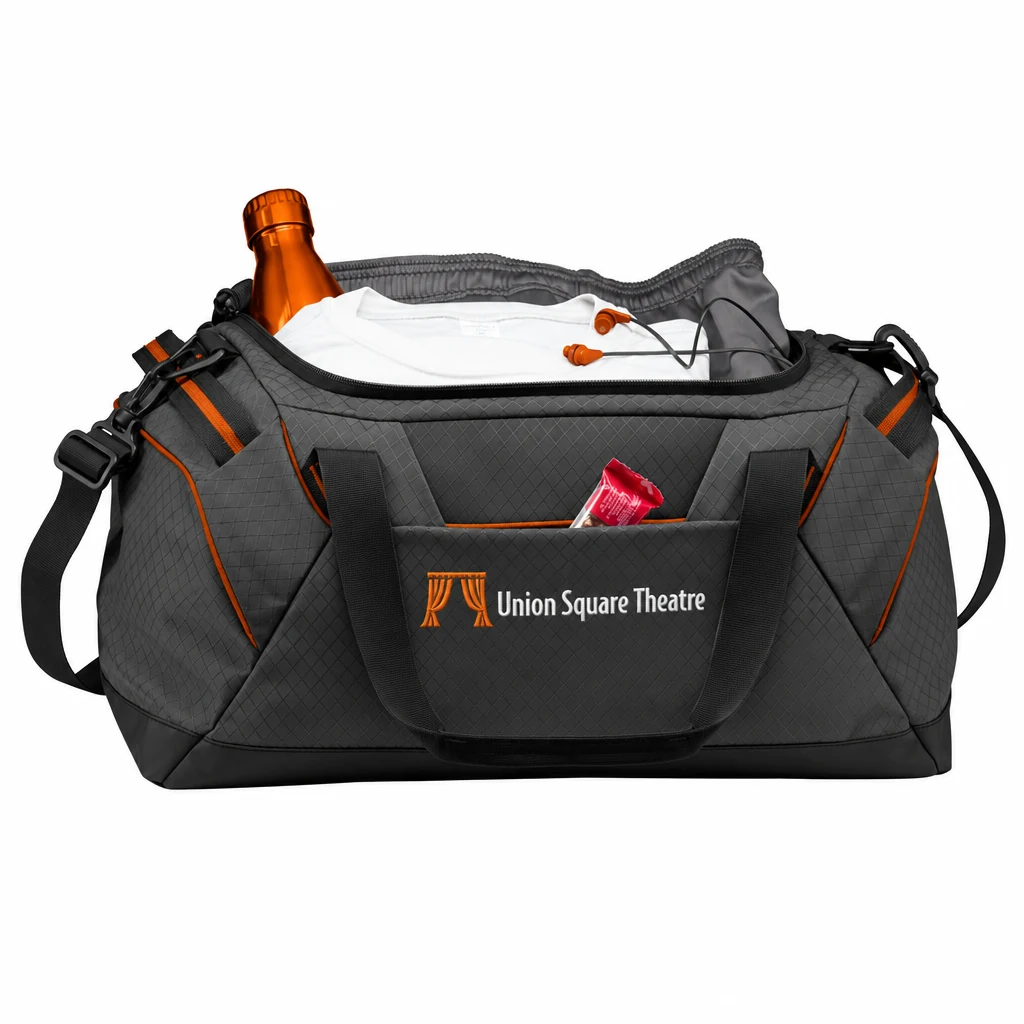 Custom OGIO Catalyst Duffel (95001) in Tarmac/ Orange, flat-lay view with a custom embroidered logo.