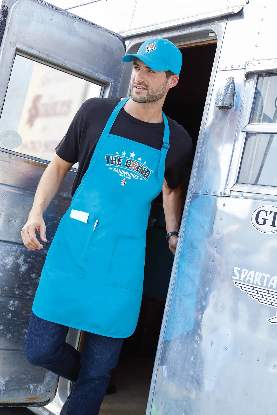 Port Authority A600 full-length apron in Sapphire with sample sandwich-shop artwork.