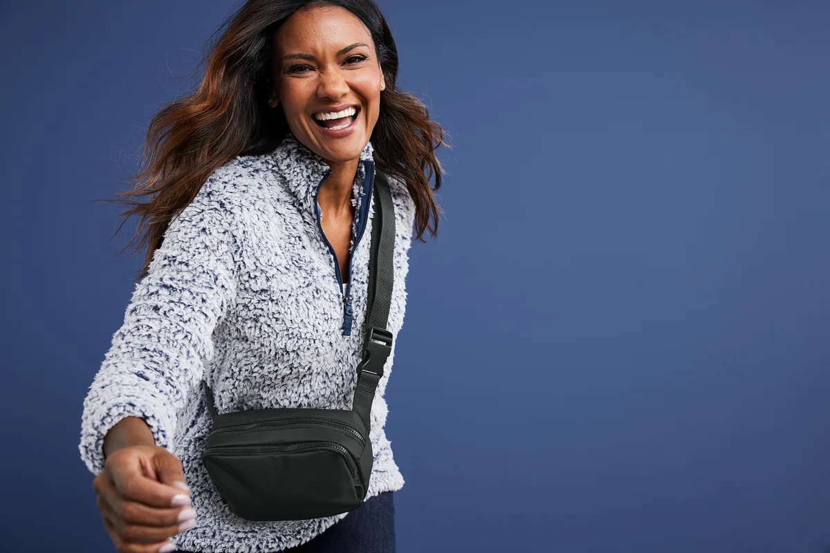 Port Authority Matte Dual-Compartment Crossbody — lifestyle photo, shown in Deep Black
