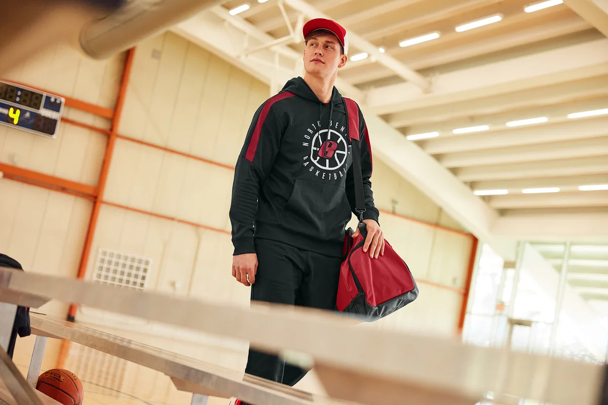 Sport-Tek Large Rec Duffel — lifestyle photo, shown in Deep Red