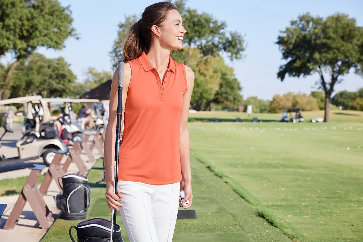 Port Authority Women's Dry Zone UV Micro-Mesh Sleeveless Polo — Style LK110SV in Coral Splash — manufacturer lifestyle photo