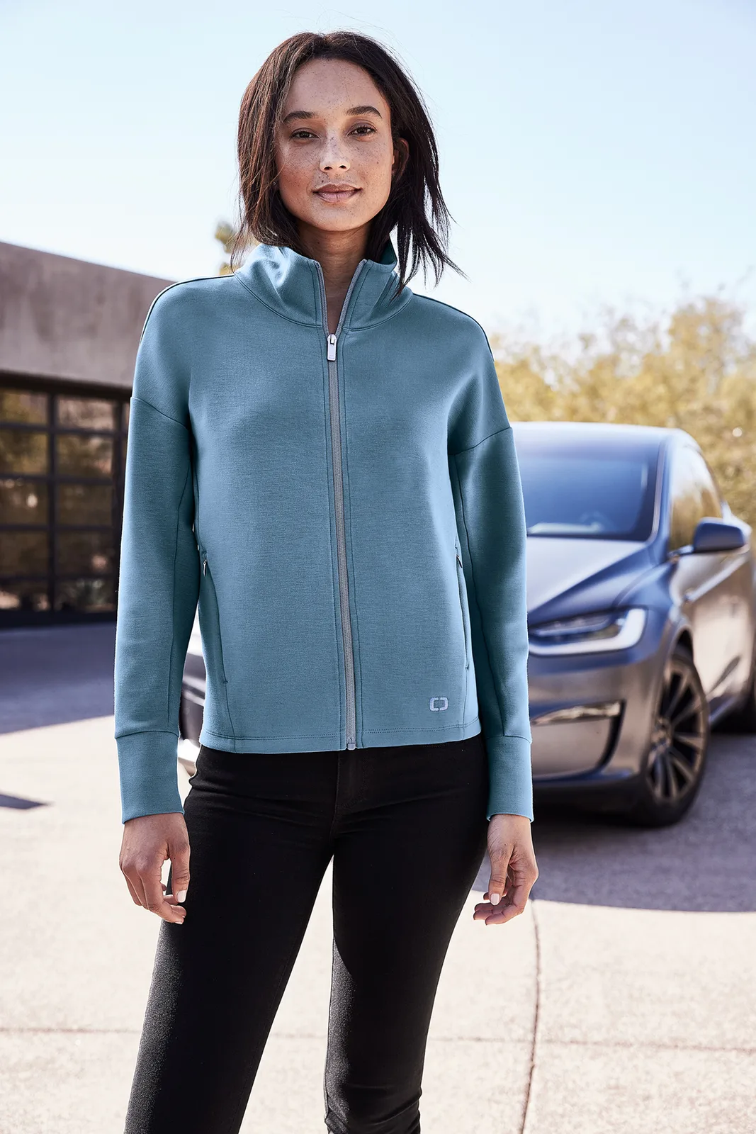 OGIO Women's Transcend Full-Zip — Style LOG860 in Blue Mist — manufacturer lifestyle photo
