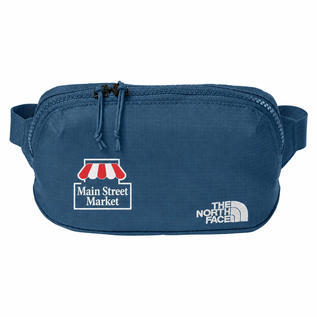 Custom The North Face 1L Travel Hip Pack (NF0A8HQV) in Shady Blue, flat-lay view with a custom printed logo.