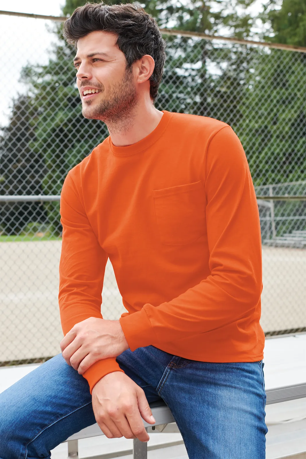 Port & Co Long Sleeve Essential Pocket Tee — Style PC61LSP in Orange — manufacturer lifestyle photo