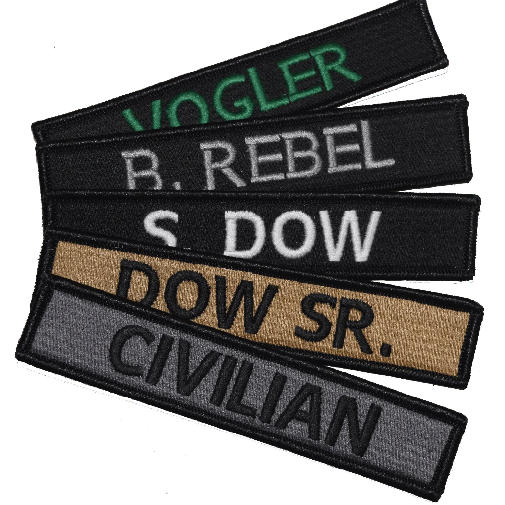 Several embroidered uniform name patches in black, tan, and gray with stitched lettering.