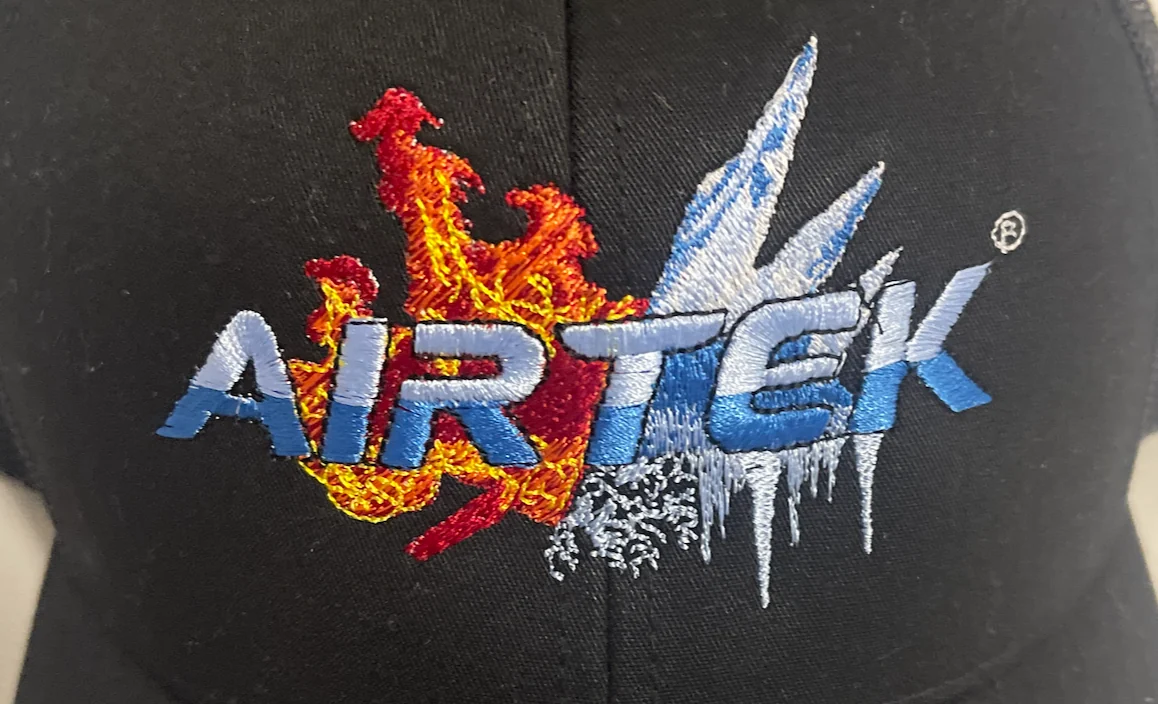 AIRTEK flame and ice multicolor logo embroidered on dark fabric