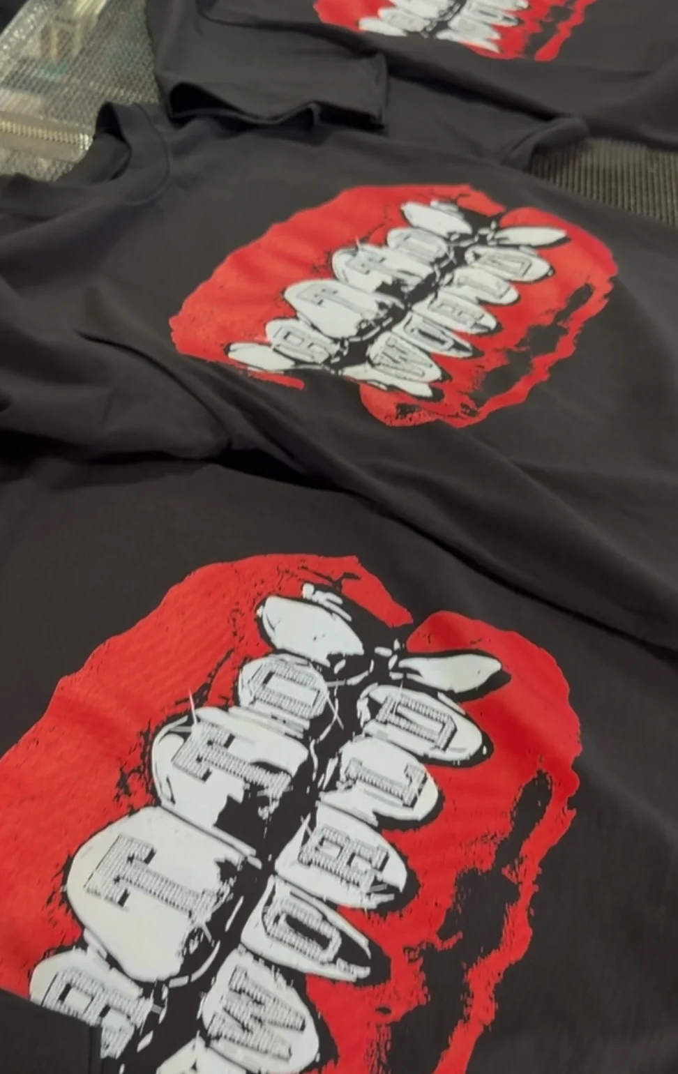 Matching red and white graphic screen printed shirts on black garments
