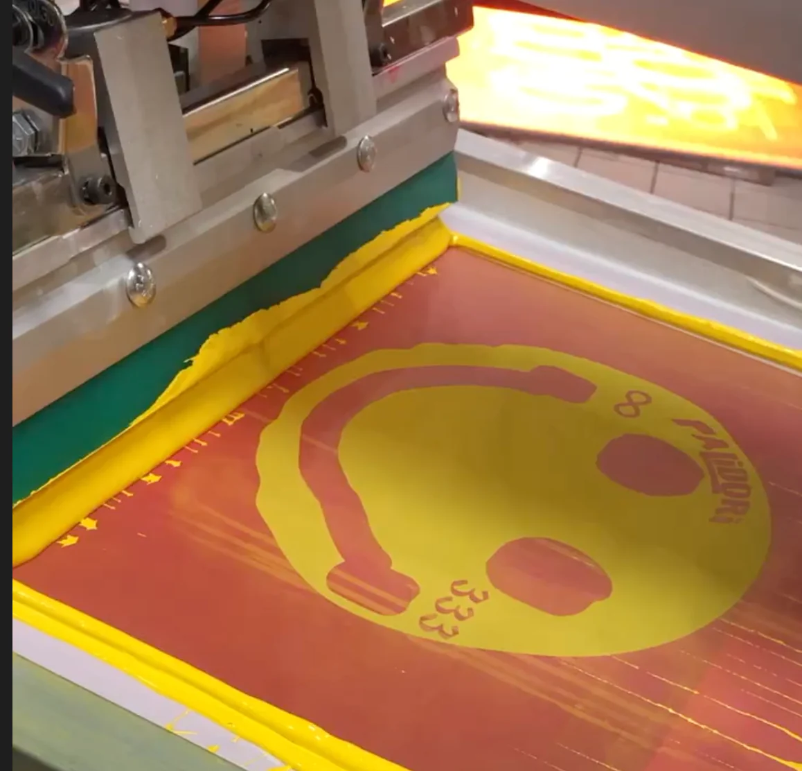 Yellow ink on a screen during custom screen printing