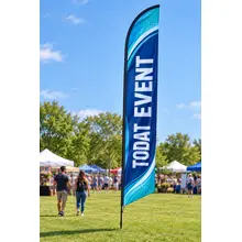 Extra-tall custom feather flag marking an outdoor event beside a lawn