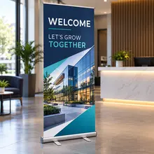 Custom retractable banner with a welcome message standing in a business lobby