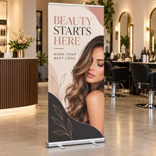 Custom retractable sign promoting a salon service inside a studio