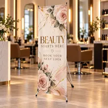 Custom X-banner sign promoting a salon service inside a studio