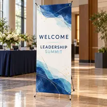 Custom X-banner with a conference message beside a meeting room